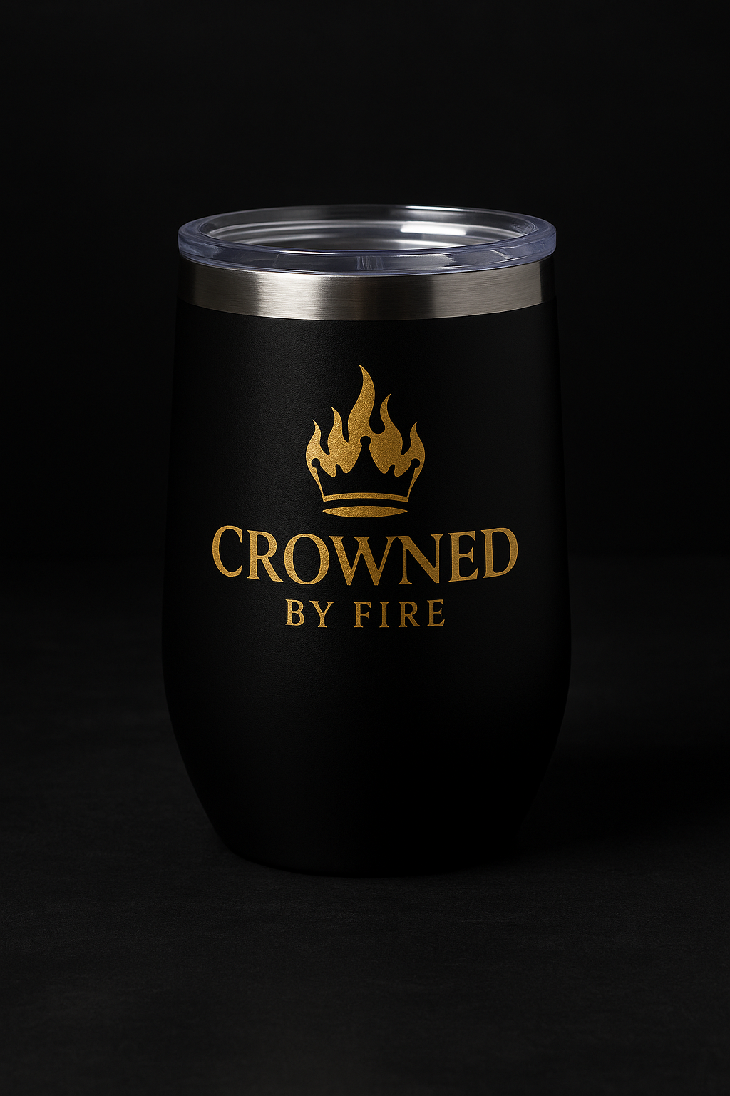 High-resolution digital photograph showcases a sleek Crowned By Fire ceramic mug in branded colors, featuring the signature crown logo, placed on a warm-toned surface with soft ambient lighting.